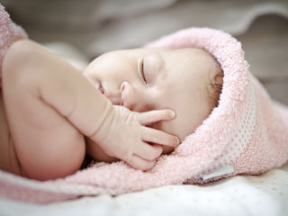 Baby wearing a pink hat